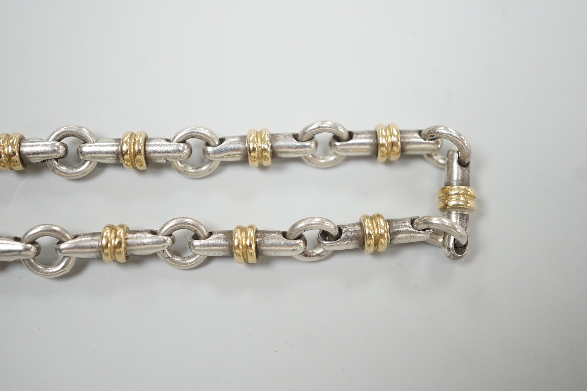 A modern Italian Tiffany & Co 750 yellow metal and 925 white metal, circular and baton link bracelet, 18cm.